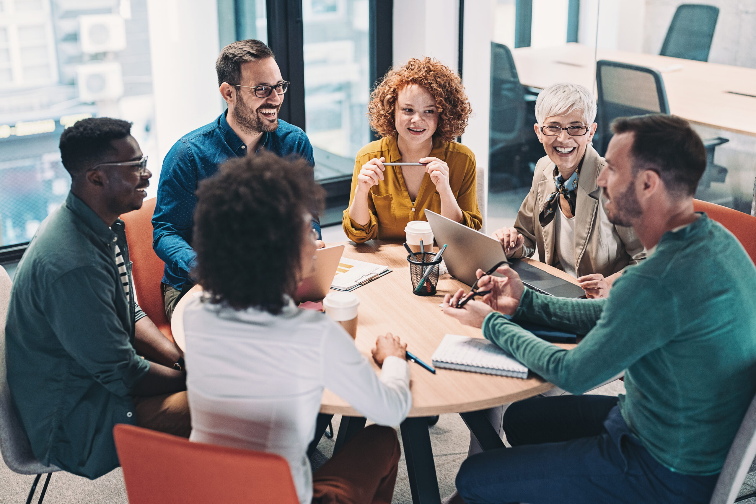 A leadership team in a team coaching session in a modern office